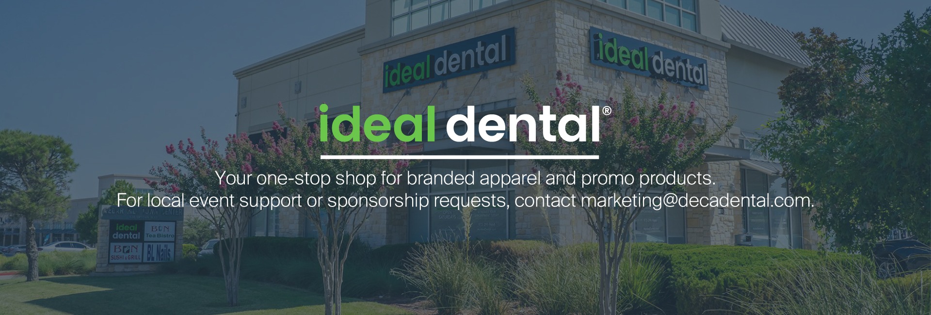 Group of professional Jani-King cleaning staff in branded uniforms standing confidently with cleaning tools